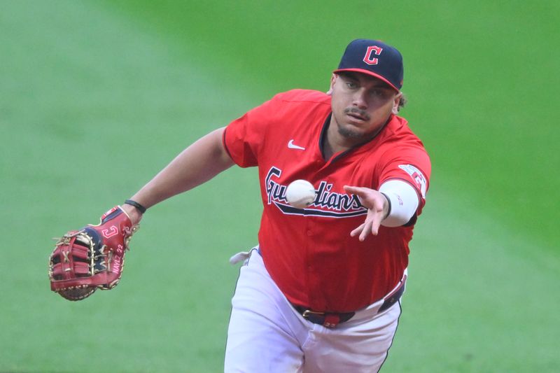 May 3, 2024; Cleveland, Ohio, USA; Cleveland Guardians first baseman Josh Naylor (22) tosses the ball to first base in the first inning against the Los Angeles Angels at Progressive Field. Mandatory Credit: David Richard-USA TODAY Sports