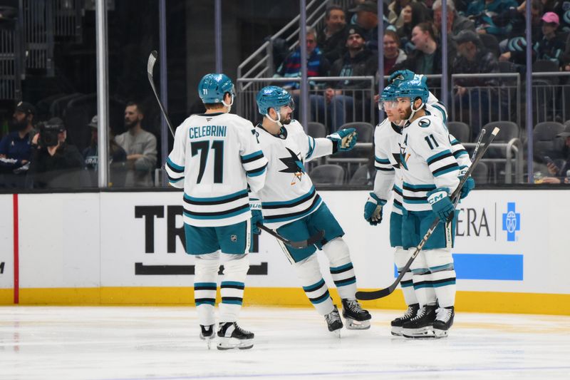 Nov 30, 2024; Seattle, Washington, USA; The San Jose Sharks celebrate after a goal scored by center Luke Kunin (11) during the second period against the Seattle Kraken at Climate Pledge Arena. Mandatory Credit: Steven Bisig-Imagn Images