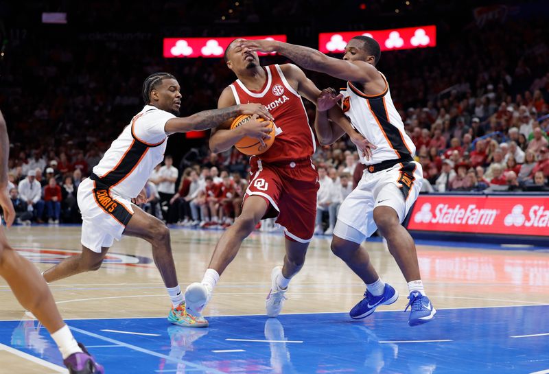 Dec 13, 2025; Oklahoma City, Oklahoma, USA; Oklahoma Sooners guard Xzayvier Brown (1) drives between Oklahoma State Cowboy defenders during the first half at Paycom Center. Mandatory Credit: Alonzo Adams-Imagn Images