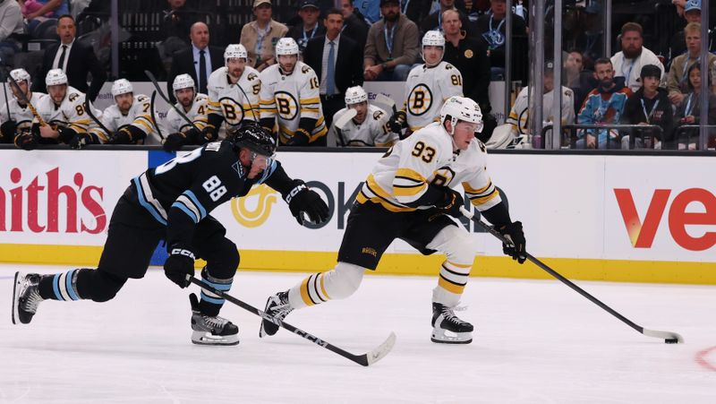 Oct 19, 2025; Salt Lake City, Utah, USA; Boston Bruins center Fraser Minten (93) skates with the puck against Utah Mammoth defenseman Nate Schmidt (88) during the second period at Delta Center. Mandatory Credit: Rob Gray-Imagn Images