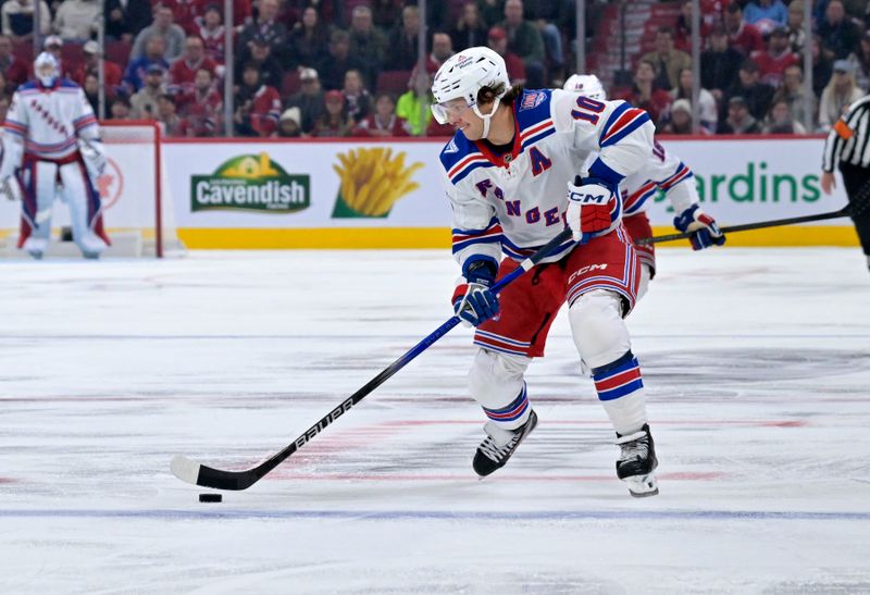 Oct 18, 2025; Montreal, Quebec, CAN; New York Rangers forward Artemi Panarin (10) plays the puck during the third period of the game against the Montreal Canadiens at the Bell Centre. Mandatory Credit: Eric Bolte-Imagn Images