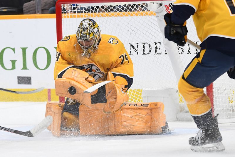 Jan 4, 2024; Nashville, Tennessee, USA; Nashville Predators goaltender Juuse Saros (74) makes a save during the second period against the Calgary Flames at Bridgestone Arena. Mandatory Credit: Christopher Hanewinckel-USA TODAY Sports