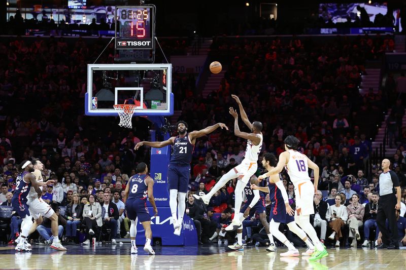 PHILADELPHIA, PENNSYLVANIA - NOVEMBER 04: Kevin Durant #35 of the Phoenix Suns shoots over Joel Embiid #21 of the Philadelphia 76ers during the first quarter at the Wells Fargo Center on November 04, 2023 in Philadelphia, Pennsylvania. NOTE TO USER: User expressly acknowledges and agrees that, by downloading and or using this photograph, User is consenting to the terms and conditions of the Getty Images License Agreement. (Photo by Tim Nwachukwu/Getty Images)