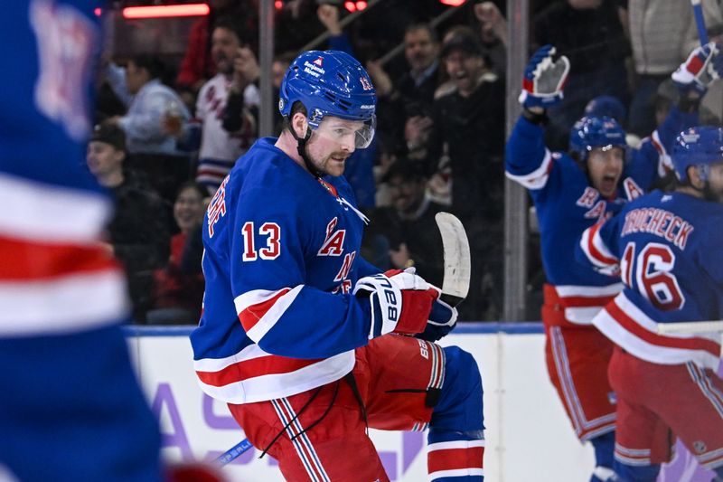 Jan 7, 2025; New York, New York, USA;  New York Rangers left wing Alexis Lafrenière (13) celebrates his first goal against the Dallas Stars during the first period at Madison Square Garden. Mandatory Credit: Dennis Schneidler-Imagn Images