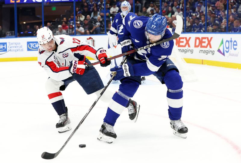 Nov 27, 2024; Tampa, Florida, USA;  Washington Capitals center Dylan Strome (17) gets called for slashing Tampa Bay Lightning defenseman Victor Hedman (77) during the second period at Amalie Arena. Mandatory Credit: Kim Klement Neitzel-Imagn Images