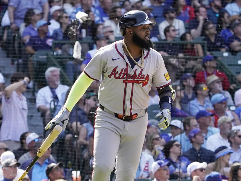 May 23, 2024; Chicago, Illinois, USA; Atlanta Braves designated hitter Marcell Ozuna (20) watches his one run sacrifice fly against the Chicago Cubs during the eighth inning  at Wrigley Field. Mandatory Credit: David Banks-USA TODAY Sports