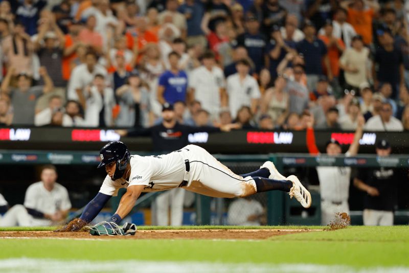 Jun 24, 2025; Detroit, Michigan, USA; Detroit Tigers outfielder Riley Greene (31) dives to score a run in the seventh inning against the Athletics at Comerica Park. Mandatory Credit: Rick Osentoski-Imagn Images