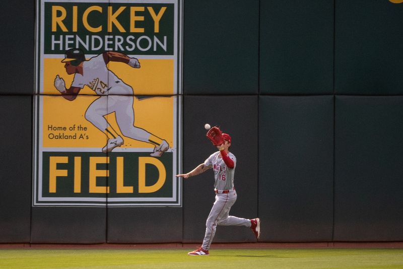 Jul 2, 2024; Oakland, California, USA; Los Angeles Angels outfielder Mickey Moniak (16) makes a catch in center field during the sixth inning of the game against the Oakland Athletics at Oakland-Alameda County Coliseum. Mandatory Credit: Ed Szczepanski-USA TODAY Sports