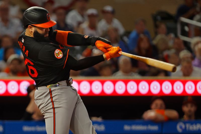 Sep 28, 2024; Minneapolis, Minnesota, USA; Baltimore Orioles third baseman Emmanuel Rivera (26) hits a solo home run against the Minnesota Twins in the fifth inning at Target Field. Mandatory Credit: Bruce Kluckhohn-Imagn Images