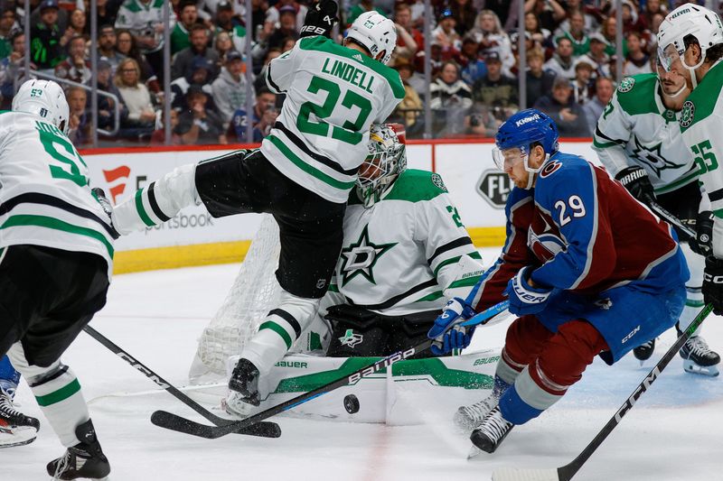 May 11, 2024; Denver, Colorado, USA; Dallas Stars defenseman Esa Lindell (23) collides with goaltender Jake Oettinger (29) as Colorado Avalanche center Nathan MacKinnon (29) controls the puck in the second period in game three of the second round of the 2024 Stanley Cup Playoffs at Ball Arena. Mandatory Credit: Isaiah J. Downing-USA TODAY Sports