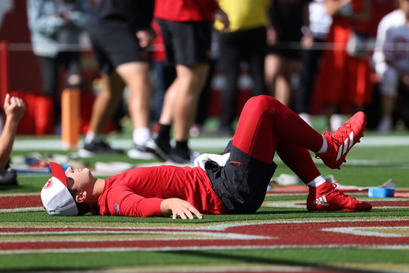 San Francisco 49ers quarterback Brock Purdy stretches before an NFL football game against the New England Patriots in Santa Clara, Calif., Sunday, Sept. 29, 2024. (AP Photo/Jed Jacobsohn)