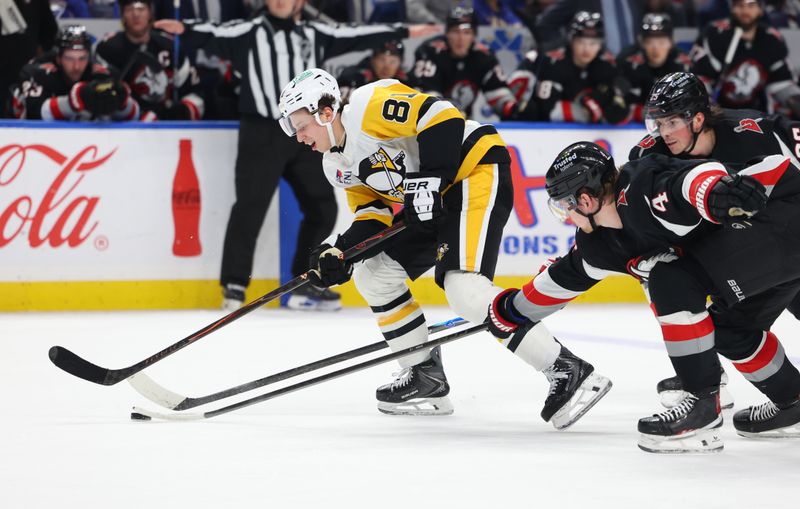 Feb 5, 2026; Buffalo, New York, USA;  Buffalo Sabres defenseman Bowen Byram (4) knocks the puck off the stick of Pittsburgh Penguins center Ben Kindel (81) during the third period at KeyBank Center. Mandatory Credit: Timothy T. Ludwig-Imagn Images