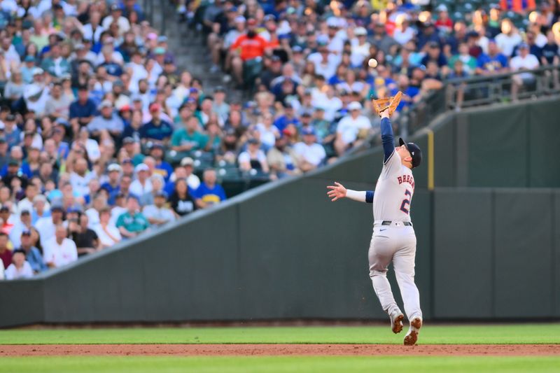 Jul 19, 2024; Seattle, Washington, USA; Houston Astros third baseman Alex Bregman (2) catches a fly ball against the Seattle Mariners during the second inning at T-Mobile Park. Mandatory Credit: Steven Bisig-USA TODAY Sports