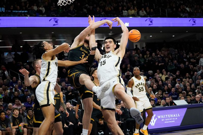 Dec 1, 2023; Evanston, Illinois, USA; Northwestern Wildcats center Matthew Nicholson (34) fouls Purdue Boilermakers center Zach Edey (15) during the first half at Welsh-Ryan Arena. Mandatory Credit: David Banks-USA TODAY Sports