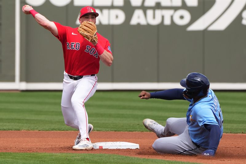 Feb 26, 2026; Fort Myers, Florida, USA;  Boston Red Sox third baseman Caleb Durbin (17) turns a double play against Tampa Bay Rays third baseman Junior Caminero (13) in the first inning as at JetBlue Park at Fenway South. Mandatory Credit: Jim Rassol-Imagn Images