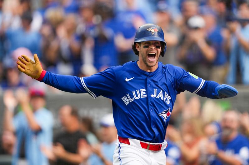 Sep 27, 2025; Toronto, Ontario, CAN; Toronto Blue Jays third base Ernie Clement (22) celebrates after scoring against the Tampa Bay Rays during the second inning at Rogers Centre. Mandatory Credit: Kevin Sousa-Imagn Images