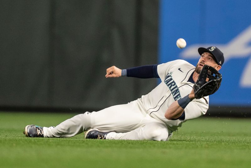 Apr 29, 2024; Seattle, Washington, USA; Seattle Mariners right fielder Mitch Haniger (17) makes a sliding catch for an out during the fourth inning against the Atlanta Braves at T-Mobile Park. Mandatory Credit: Stephen Brashear-USA TODAY Sports