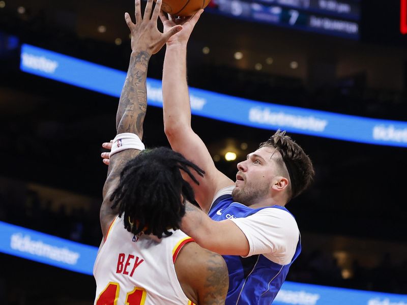 ATLANTA, GEORGIA - JANUARY 26: Luka Doncic #77 of the Dallas Mavericks goes up for a shot against Saddiq Bey #41 of the Atlanta Hawks during the first quarter at State Farm Arena on January 26, 2024 in Atlanta, Georgia. NOTE TO USER: User expressly acknowledges and agrees that, by downloading and or using this photograph, User is consenting to the terms and conditions of the Getty Images License Agreement. (Photo by Todd Kirkland/Getty Images)