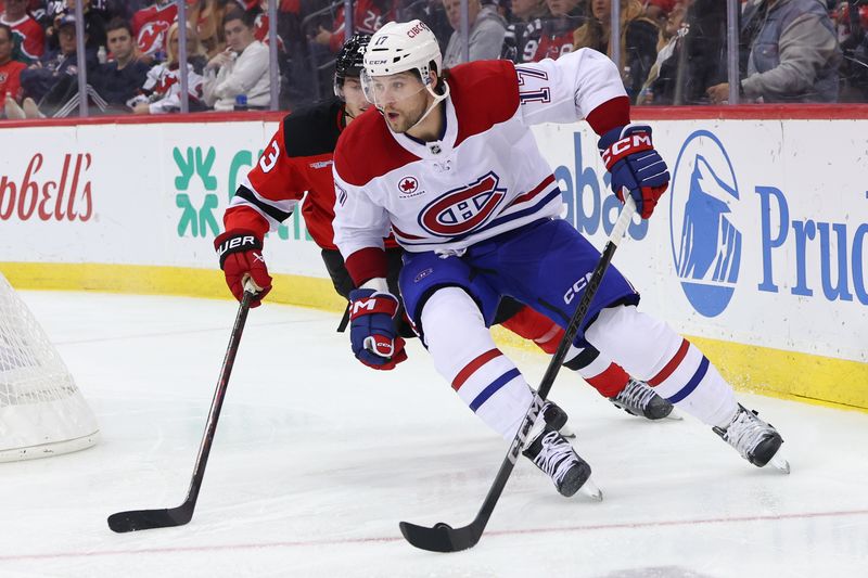 Nov 7, 2024; Newark, New Jersey, USA; Montreal Canadiens right wing Josh Anderson (17) skates with the puck while being defended by New Jersey Devils defenseman Luke Hughes (43) during the third period at Prudential Center. Mandatory Credit: Ed Mulholland-Imagn Images