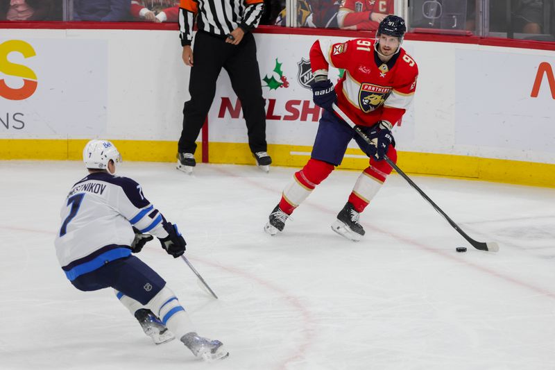 Nov 24, 2023; Sunrise, Florida, USA; Florida Panthers defenseman Oliver Ekman-Larsson (91) moves the puck against the Winnipeg Jets during the third period at Amerant Bank Arena. Mandatory Credit: Sam Navarro-USA TODAY Sports