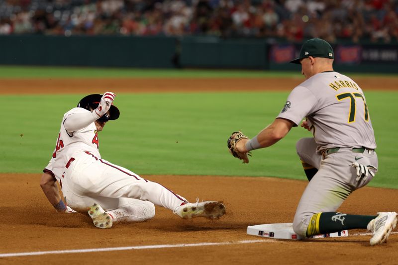 Jul 25, 2024; Anaheim, California, USA;  Los Angeles Angels center fielder Mickey Moniak (16) is out at third base as Oakland Athletics third baseman Brett Harris (77) applies the tag during the seventh inning against the Oakland Athletics at Angel Stadium. Mandatory Credit: Kiyoshi Mio-USA TODAY Sports