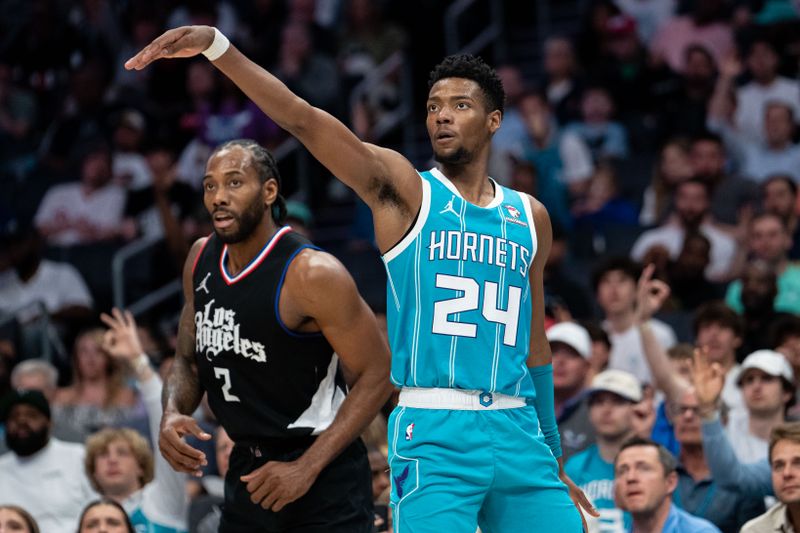 CHARLOTTE, NORTH CAROLINA - MARCH 31: Brandon Miller #24 of the Charlotte Hornets watches his shot while guarded by Kawhi Leonard #2 of the LA Clippers in the third quarter during their game at Spectrum Center on March 31, 2024 in Charlotte, North Carolina. NOTE TO USER: User expressly acknowledges and agrees that, by downloading and or using this photograph, User is consenting to the terms and conditions of the Getty Images License Agreement. (Photo by Jacob Kupferman/Getty Images)