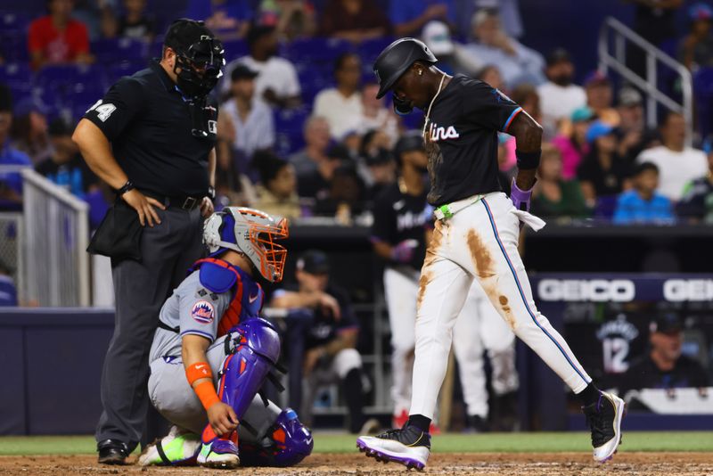 Jul 19, 2024; Miami, Florida, USA; Miami Marlins center fielder Jazz Chisholm Jr. (2) scores after a base hit by first baseman Jake Burger (not pictured) against the New York Mets during the third inning at loanDepot Park. Mandatory Credit: Sam Navarro-USA TODAY Sports