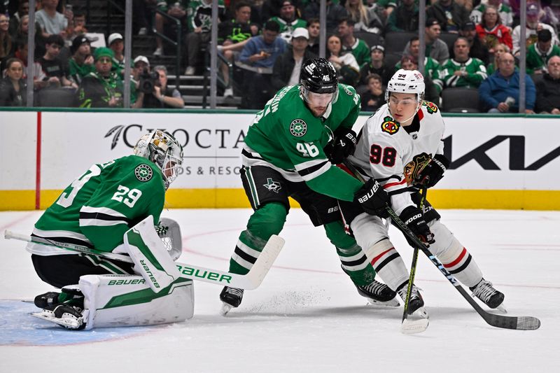 Nov 7, 2024; Dallas, Texas, USA; Chicago Blackhawks center Connor Bedard (98) skates Dallas Stars defenseman Ilya Lyubushkin (46) and goaltender Jake Oettinger (29) during the first period at the American Airlines Center. Mandatory Credit: Jerome Miron-Imagn Images