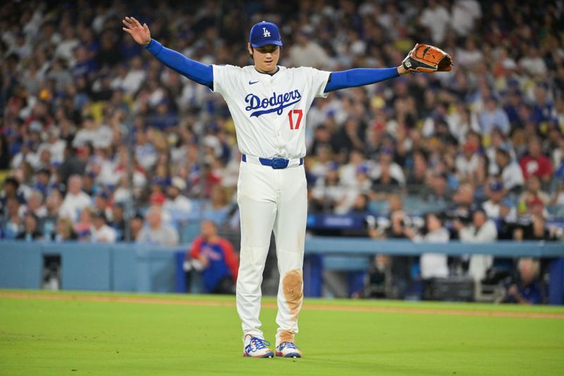Sep 16, 2025; Los Angeles, California, USA; Los Angeles Dodgers two-way player Shohei Ohtani (17) reacts after right fielder Alex Call (12) saves a home run hit by Philadelphia Phillies left fielder Max Kepler (17) during the fifth inning at Dodger Stadium. Mandatory Credit: Jayne Kamin-Oncea-Imagn Images