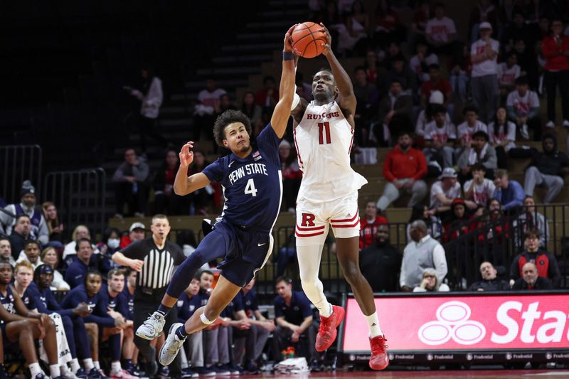 Jan 31, 2024; Piscataway, New Jersey, USA; Rutgers Scarlet Knights center Clifford Omoruyi (11) fights for the ball against Penn State Nittany Lions forward Puff Johnson (4) during the second half at Jersey Mike's Arena. Mandatory Credit: Vincent Carchietta-USA TODAY Sports