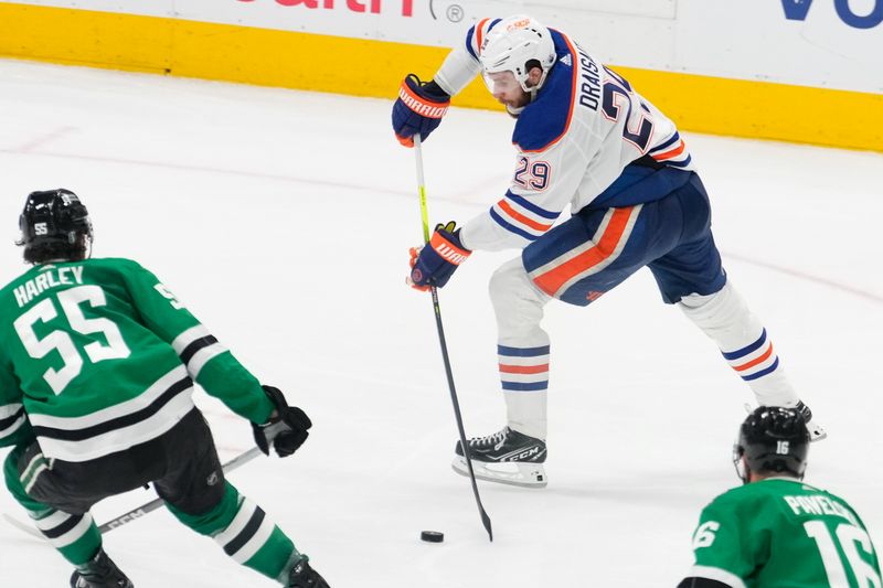 May 31, 2024; Dallas, Texas, USA; Dallas Stars goaltender Jake Oettinger (29) passes the puck against Dallas Stars defenseman Thomas Harley (55) during the third period between the Dallas Stars and the Edmonton Oilers in game five of the Western Conference Final of the 2024 Stanley Cup Playoffs at American Airlines Center. Mandatory Credit: Chris Jones-USA TODAY Sports