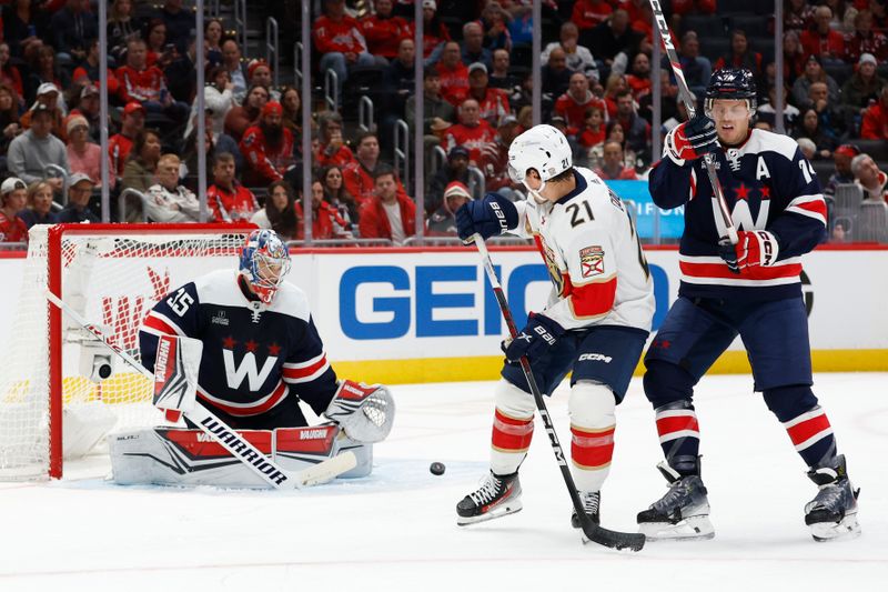 Nov 8, 2023; Washington, District of Columbia, USA; Washington Capitals goaltender Darcy Kuemper (35) makes a save as Florida Panthers center Nick Cousins (21) and Capitals defenseman John Carlson (74) look on in the second period at Capital One Arena. Mandatory Credit: Geoff Burke-USA TODAY Sports