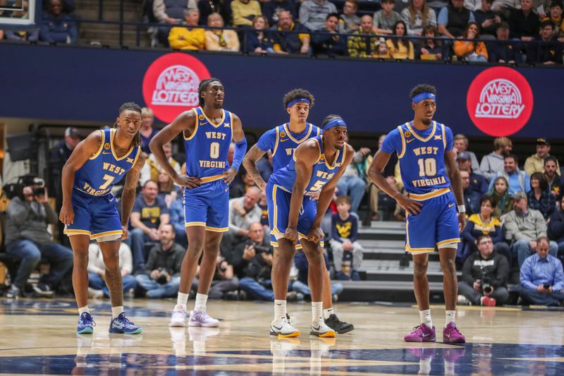 Jan 18, 2025; Morgantown, West Virginia, USA; West Virginia Mountaineers players pause on the court during the first half against the Iowa State Cyclones at WVU Coliseum. Mandatory Credit: Ben Queen-Imagn Images
