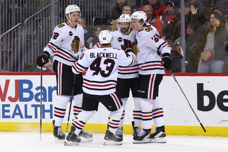 Jan 5, 2024; Newark, New Jersey, USA; Chicago Blackhawks center Jason Dickinson (16) celebrates his goal against the New Jersey Devils during the first period at Prudential Center. Mandatory Credit: Ed Mulholland-USA TODAY Sports