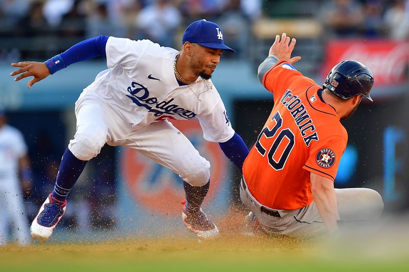 Jun 25, 2023; Los Angeles, California, USA; Houston Astros left fielder Chas McCormick (20) is caught stealing second by Los Angeles Dodgers second baseman Mookie Betts (50) during the ninth inning at Dodger Stadium. Mandatory Credit: Gary A. Vasquez-USA TODAY Sports