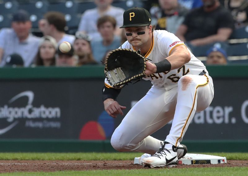 Apr 29, 2025; Pittsburgh, Pennsylvania, USA;  Pittsburgh Pirates first baseman Matt Gorski (62) takes a throw for an out against the Chicago Cubs during the third inning at PNC Park. Mandatory Credit: Charles LeClaire-Imagn Images