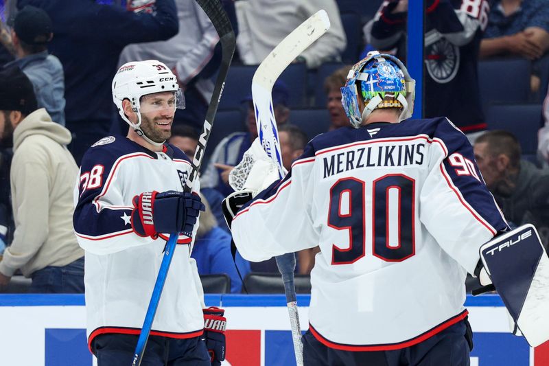 Mar 10, 2026; Tampa, Florida, USA; Columbus Blue Jackets goaltender Elvis Merzlikins (90) reacts to a goal by defenseman Dante Fabbro (15) against the Tampa Bay Lightning in the third period at Benchmark International Arena. Mandatory Credit: Nathan Ray Seebeck-Imagn Images