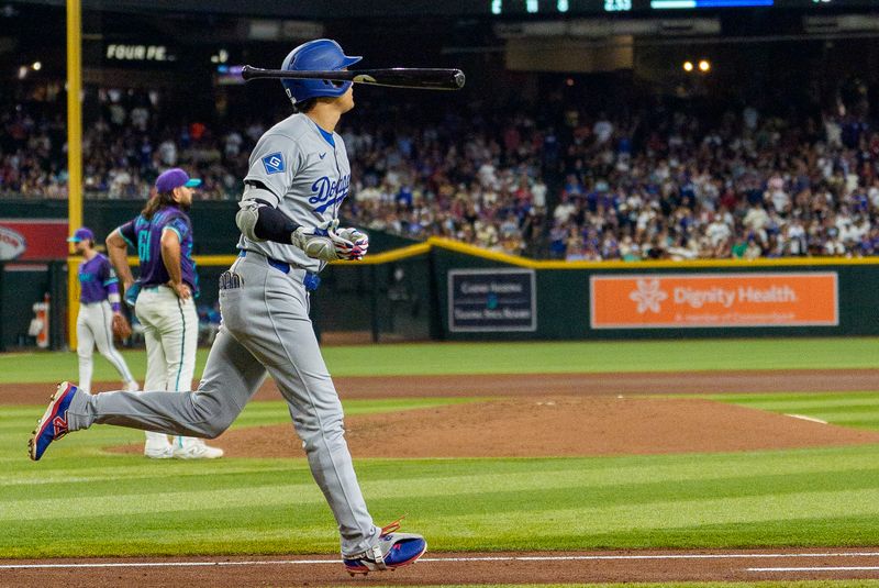 Sep 25, 2025; Phoenix, Arizona, USA; Los Angeles Dodgers designated hitter Shohei Ohtani (17) reacts by throwing his bat after hitting a home run in the fourth inning against the Arizona Diamondbacks at Chase Field. Mandatory Credit: Allan Henry-Imagn Images