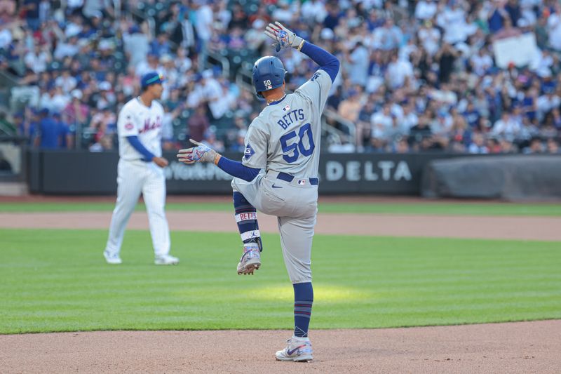 May 28, 2024; New York, NY, USA; Los Angeles Dodgers shortstop Mookie Betts (50) reacts after an RBI single during the tenth inning against the New York Mets at Citi Field. Mandatory Credit: Vincent Carchietta-USA TODAY Sports