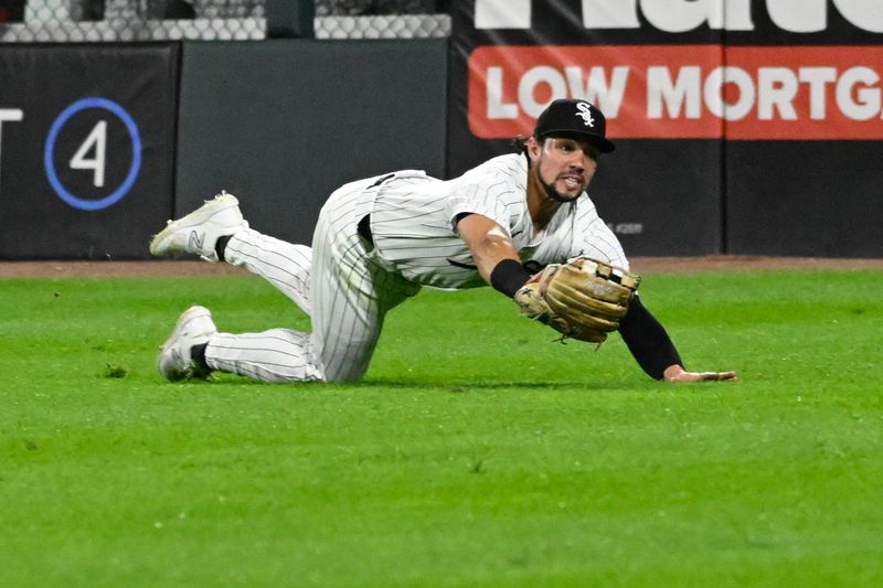 Sep 25, 2024; Chicago, Illinois, USA;  Chicago White Sox outfielder Dominic Fletcher (7) catches a fly ball hit by Los Angeles Angels outfielder Taylor Ward (3) during the seventh inning at Guaranteed Rate Field. Mandatory Credit: Matt Marton-Imagn Images