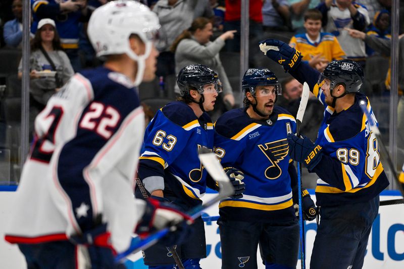 Oct 1, 2024; St. Louis, Missouri, USA;  St. Louis Blues defenseman Justin Faulk (72) is congratulated by left wing Jake Neighbours (63) and left wing Pavel Buchnevich (89) after scoring against the Columbus Blue Jackets during the second period at Enterprise Center. Mandatory Credit: Jeff Curry-Imagn Images