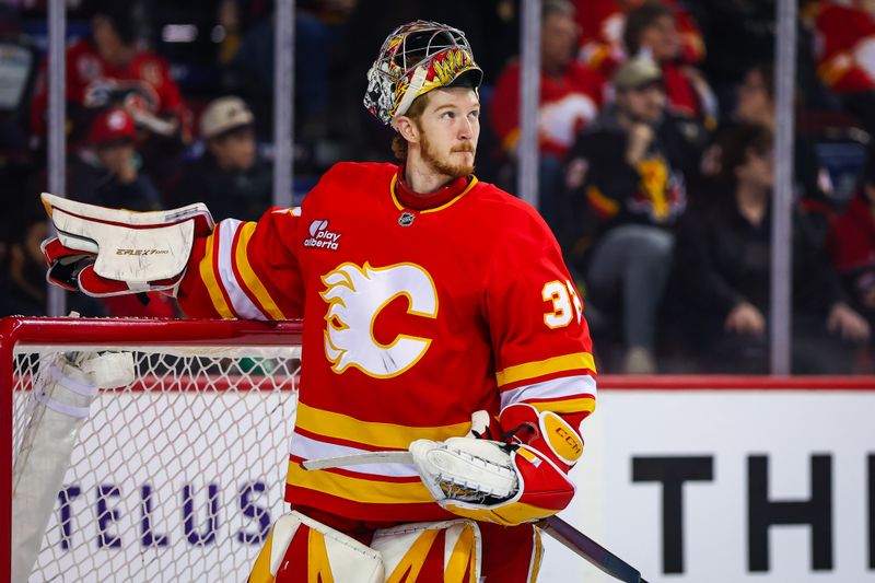 Jan 25, 2026; Calgary, Alberta, CAN; Calgary Flames goaltender Dustin Wolf (32) reacts during the first period against the Anaheim Ducks at Scotiabank Saddledome. Mandatory Credit: Sergei Belski-Imagn Images