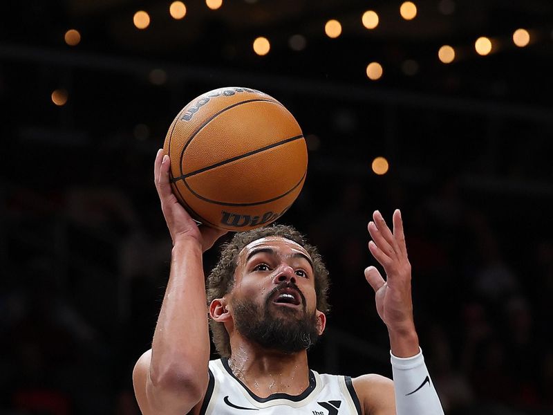 ATLANTA, GEORGIA - JANUARY 28:  Trae Young #11 of the Atlanta Hawks attempts a basket against the Houston Rockets during the first quarter at State Farm Arena on January 28, 2025 in Atlanta, Georgia.  NOTE TO USER: User expressly acknowledges and agrees that, by downloading and/or using this photograph, user is consenting to the terms and conditions of the Getty Images License Agreement.  (Photo by Kevin C. Cox/Getty Images)