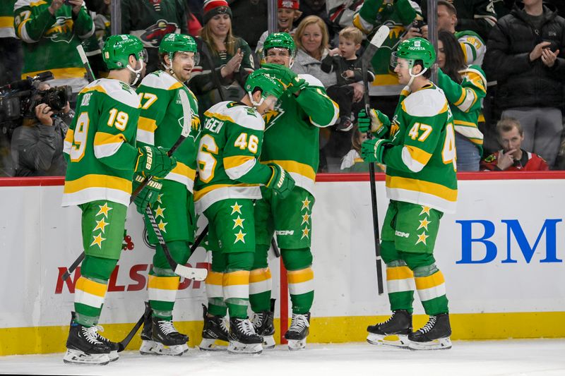 Nov 29, 2024; Saint Paul, Minnesota, USA;  Minnesota Wild defenseman Jared Spurgeon (46) celebrates his second goal of the game against the Chicago Blackhawks with forward Devin Shore (19), forward Marcus Foligno (17), forward Joel Eriksson Ek (14), and defenseman Declan Chisholm (47) during the second period at Xcel Energy Center. Mandatory Credit: Nick Wosika-Imagn Images