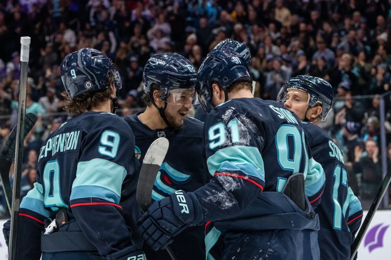 Nov 20, 2024; Seattle, Washington, USA;  Seattle Kraken, from left, forward Chandler Stephenson (9), defenseman Brandon Montour (62), forward Daniel Sprong (91) and forward Jaden Schwartz (17) celebrate a goald during the second period at Climate Pledge Arena. Mandatory Credit: Stephen Brashear-Imagn Images