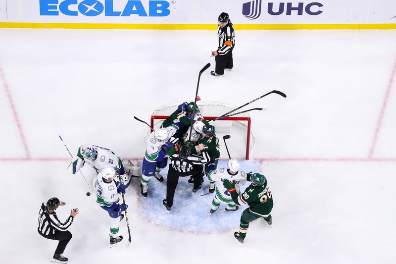 Dec 3, 2024; Saint Paul, Minnesota, USA; Minnesota Wild center Joel Eriksson Ek (14) gets into a scrum with Vancouver Canucks defenseman Carson Soucy (7) and left wing Kiefer Sherwood (44) during the first period at Xcel Energy Center. Mandatory Credit: Matt Krohn-Imagn Images