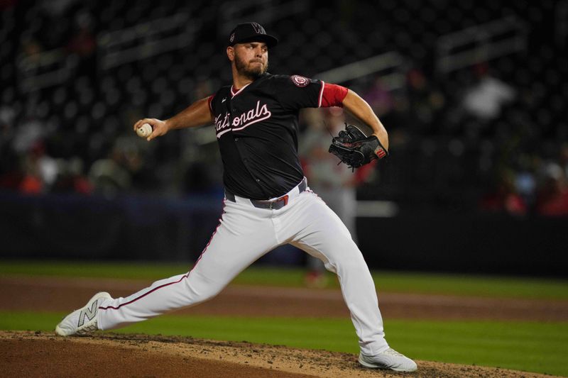 Mar 8, 2024; West Palm Beach, Florida, USA:  Washington Nationals relief pitcher Tanner Rainey (21) pitches in the fourth inning against the St. Louis Cardinals at CACTI Park of the Palm Beaches. Mandatory Credit: Jim Rassol-USA TODAY Sports