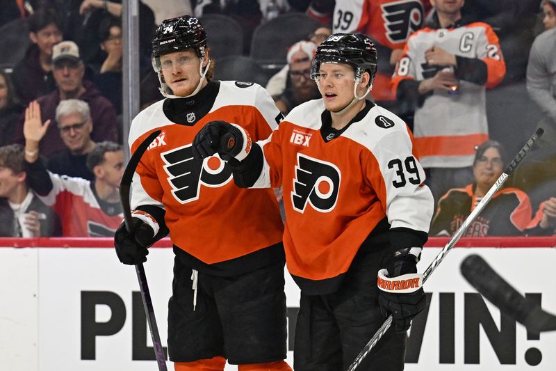 Jan 10, 2026; Philadelphia, Pennsylvania, USA; Philadelphia Flyers right wing Owen Tippett (74) celebrates his goal with right wing Matvei Michkov (39) against the Tampa Bay Lightning during the third period at Xfinity Mobile Arena. Mandatory Credit: Eric Hartline-Imagn Images