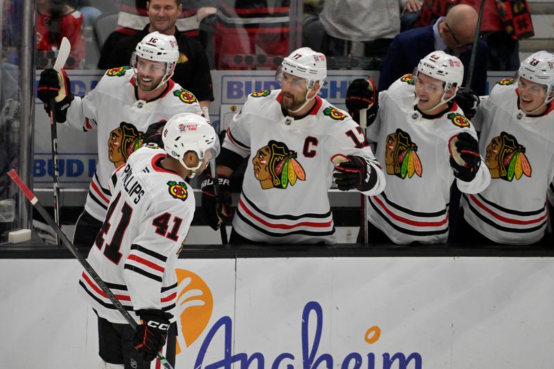 Nov 3, 2024; Anaheim, California, USA;  Chicago Blackhawks defenseman Isaak Phillips (41) is congratulated at the bench after scoring a goal in the first period against the Anaheim Ducks at Honda Center. Mandatory Credit: Jayne Kamin-Oncea-Imagn Images