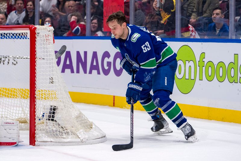 Mar 21, 2024; Vancouver, British Columbia, CAN; Vancouver Canucks forward Teddy Blueger (53) handles the puck against the Montreal Canadiens in the third period at Rogers Arena. Vancouver won 4 -1. Mandatory Credit: Bob Frid-USA TODAY Sports